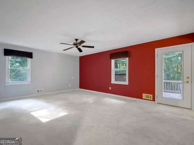 carpeted empty room featuring ceiling fan and a healthy amount of sunlight