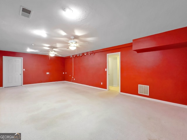 empty room featuring carpet flooring and ceiling fan