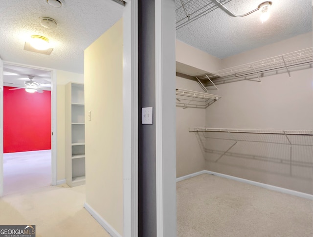 spacious closet with carpet flooring and ceiling fan