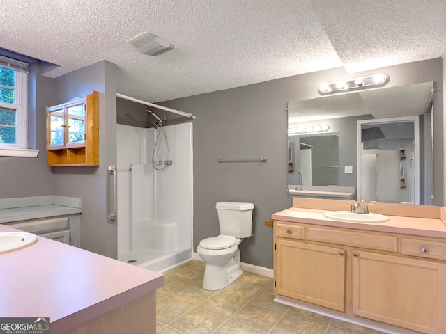 bathroom with toilet, a textured ceiling, tile patterned floors, and walk in shower