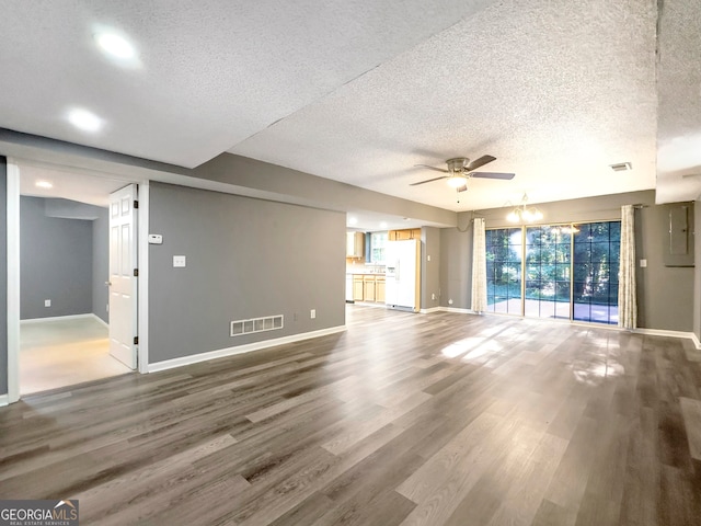 unfurnished living room with hardwood / wood-style floors, a textured ceiling, electric panel, and ceiling fan