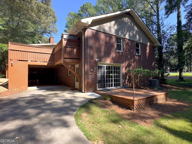 view of home's exterior with a wooden deck, central AC unit, and a garage