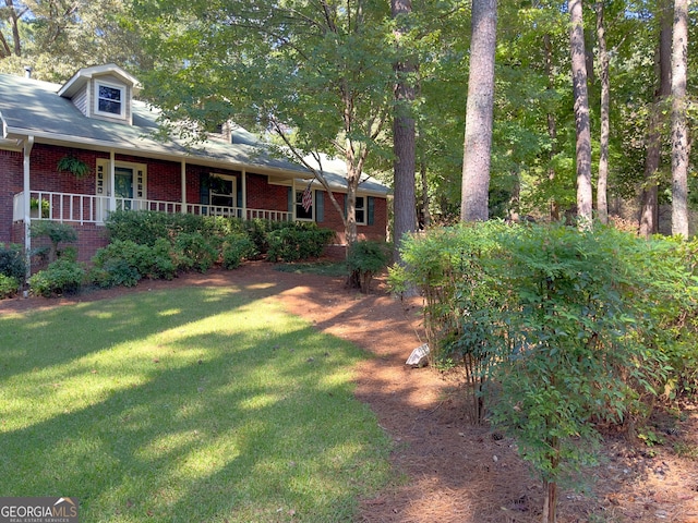 view of yard featuring covered porch