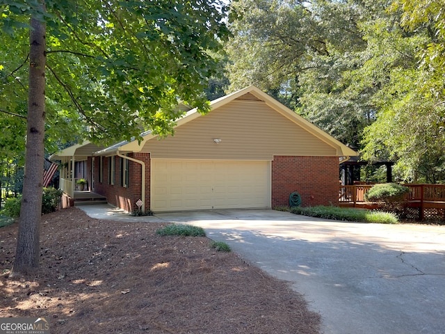 view of side of property featuring a wooden deck and a garage