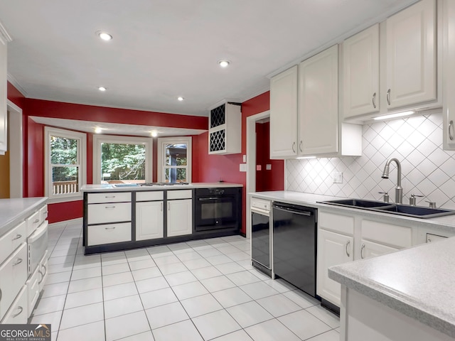 kitchen with decorative backsplash, sink, white cabinetry, and black appliances