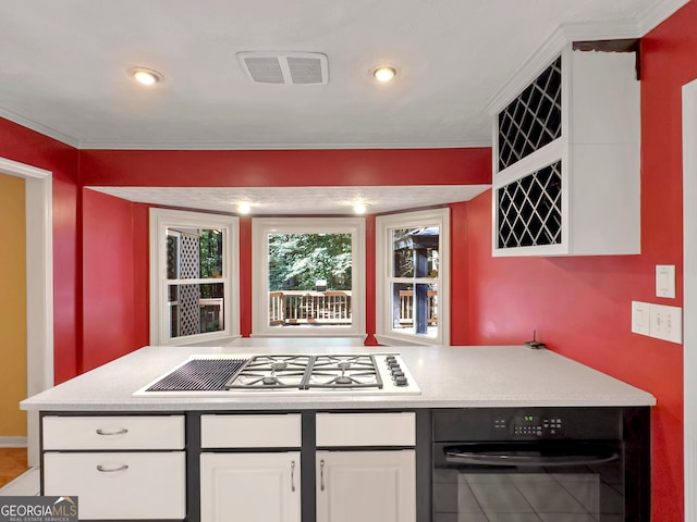 kitchen with black oven, white cabinetry, and stainless steel gas cooktop