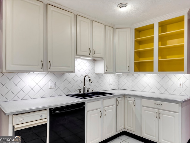 kitchen featuring dishwasher, sink, a textured ceiling, decorative backsplash, and white cabinets