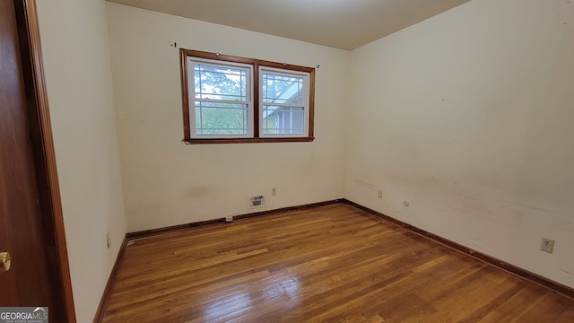 empty room with wood-type flooring