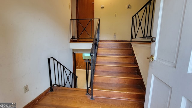 stairway featuring wood-type flooring