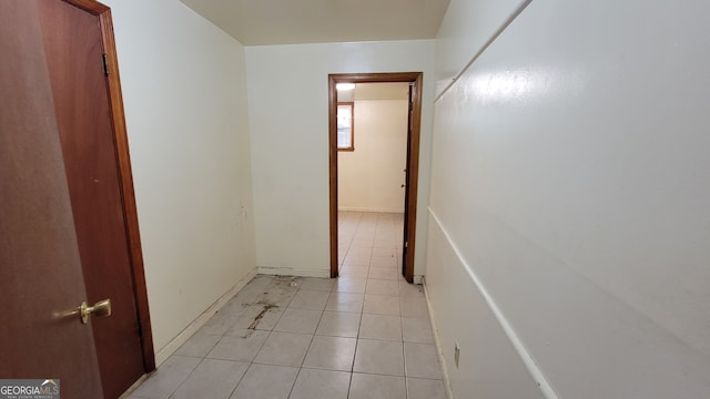 hall featuring light tile patterned floors