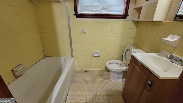 bathroom with tile patterned floors, vanity, tile walls, and toilet