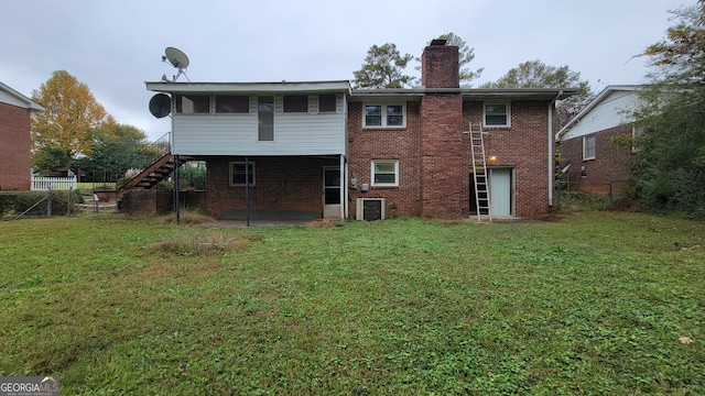 rear view of property featuring a yard