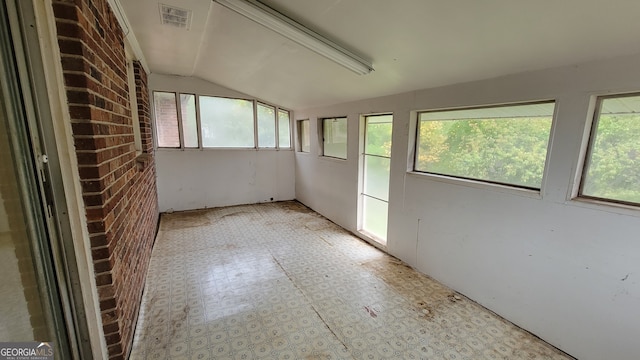 unfurnished sunroom with vaulted ceiling