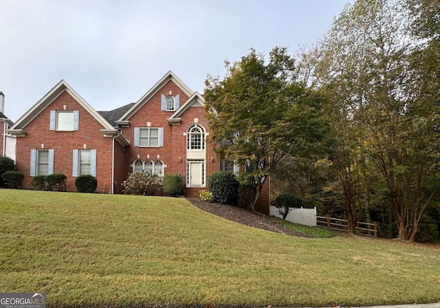 view of property featuring a front lawn