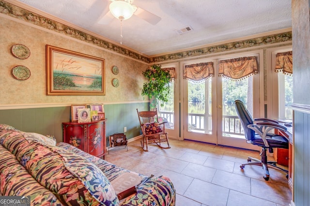 tiled home office with french doors, a textured ceiling, ceiling fan, and ornamental molding