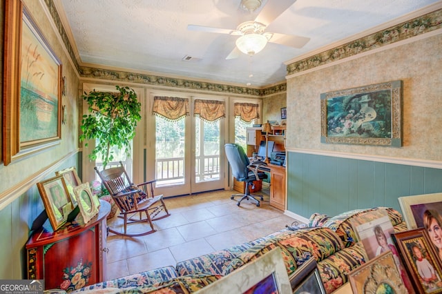 tiled office space featuring ceiling fan, wood walls, a textured ceiling, and ornamental molding