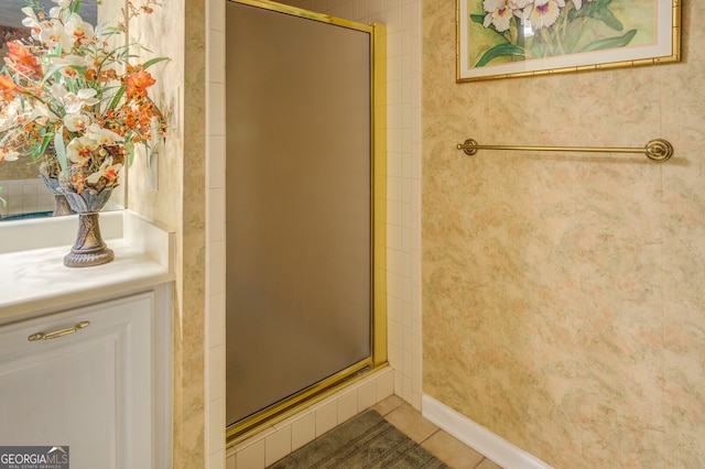 bathroom featuring tile patterned floors and a shower with shower door