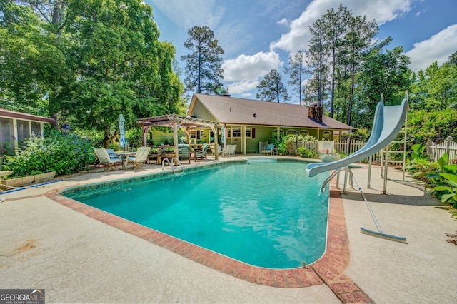 view of pool featuring a pergola, a patio area, and a water slide