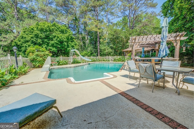 view of swimming pool with a pergola, a patio, and a water slide