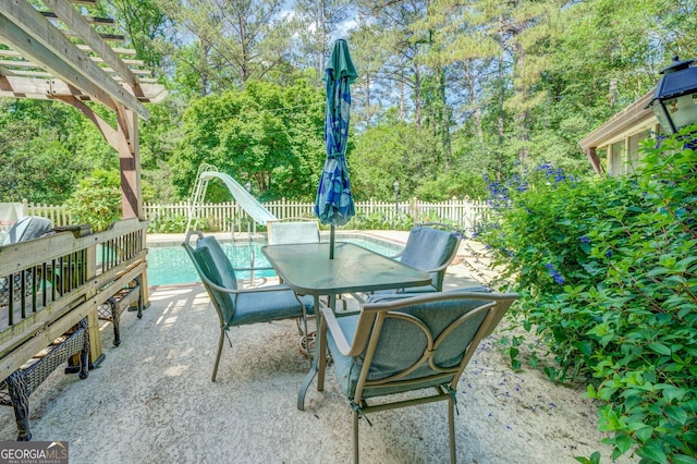 view of patio with a fenced in pool and a pergola