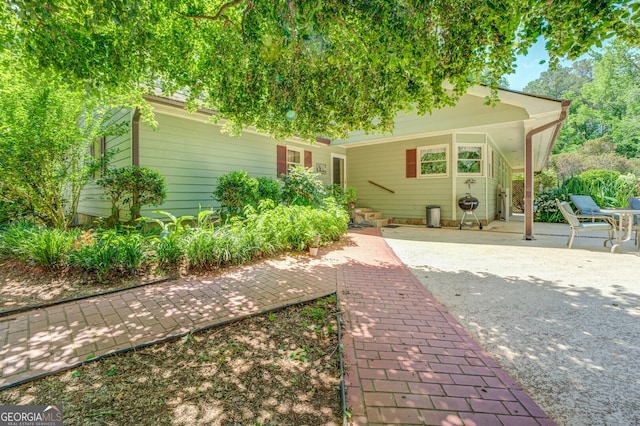 rear view of property featuring a patio