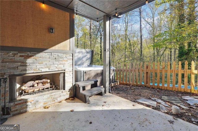 view of patio / terrace with an outdoor stone fireplace