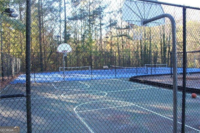 view of basketball court featuring tennis court