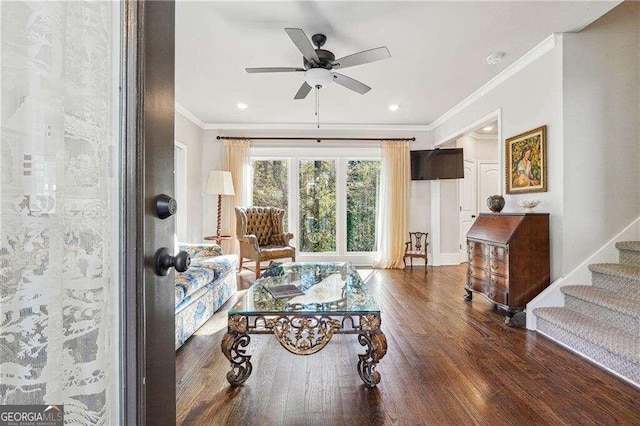 living room featuring ceiling fan, dark hardwood / wood-style flooring, and crown molding