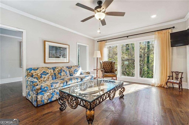 living room featuring ceiling fan, dark hardwood / wood-style floors, and ornamental molding