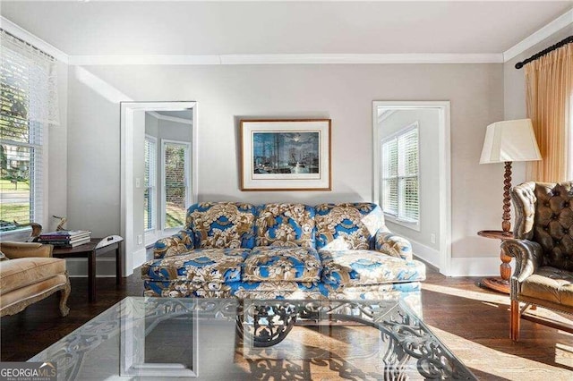 living room featuring crown molding, a healthy amount of sunlight, and dark hardwood / wood-style floors