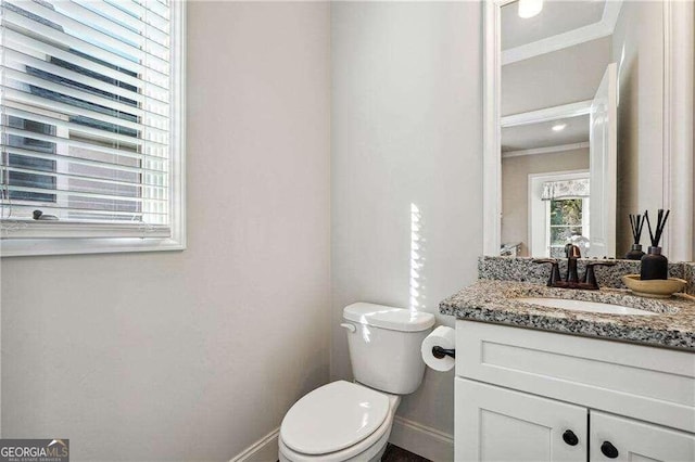 bathroom with vanity, ornamental molding, and toilet