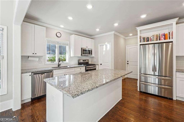 kitchen with white cabinets, a kitchen island, and stainless steel appliances