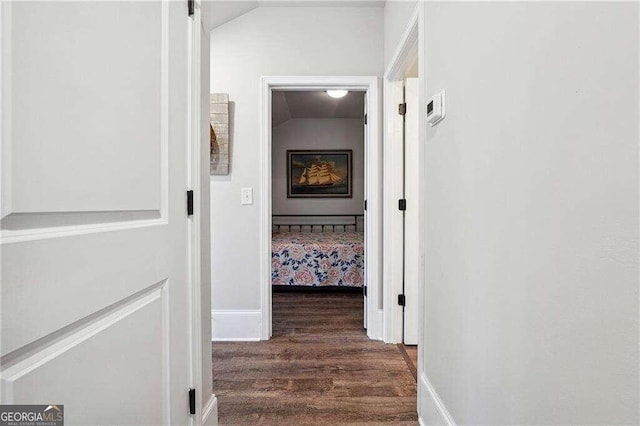 corridor featuring dark hardwood / wood-style floors and lofted ceiling