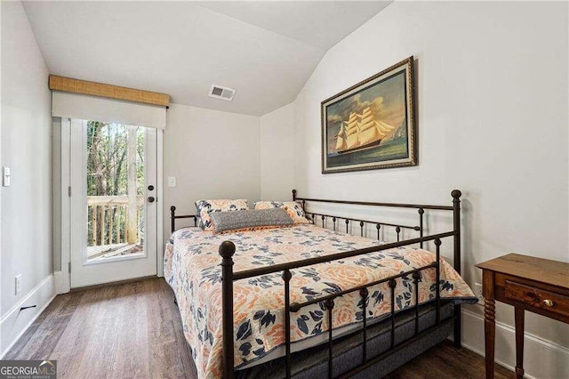 bedroom with access to outside, dark hardwood / wood-style floors, and lofted ceiling