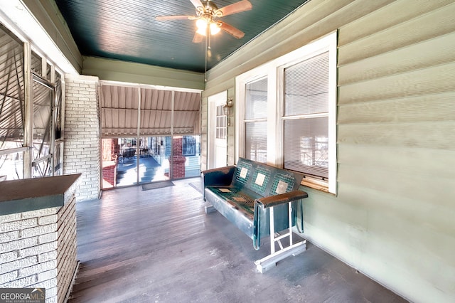 interior space with ceiling fan and a porch