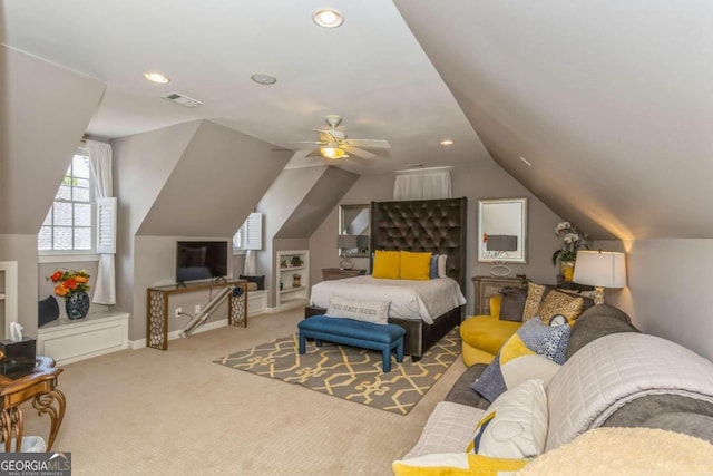 bedroom with ceiling fan, light carpet, and vaulted ceiling