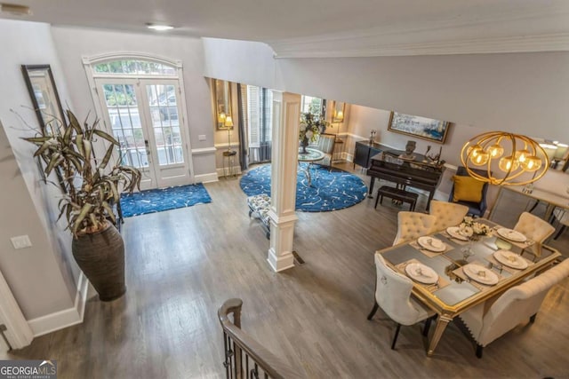 entrance foyer featuring french doors, vaulted ceiling, ornamental molding, wood-type flooring, and a chandelier