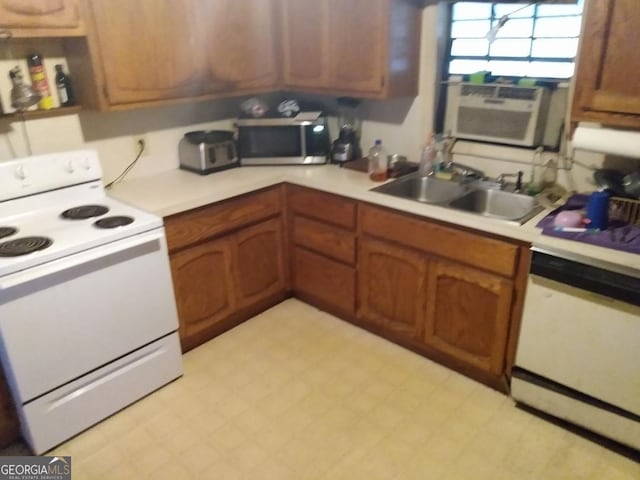 kitchen with cooling unit, white appliances, and sink