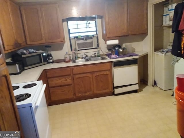 kitchen with sink, cooling unit, white appliances, and washer / dryer