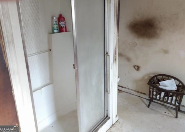 bathroom featuring concrete floors and an enclosed shower