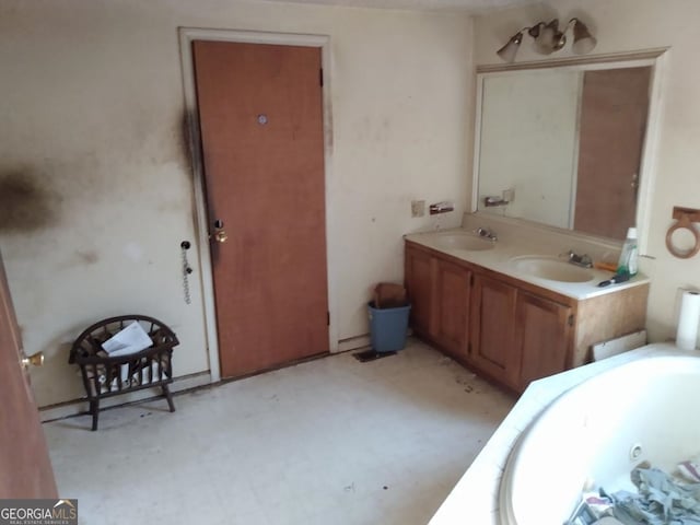 bathroom with a tub to relax in and vanity