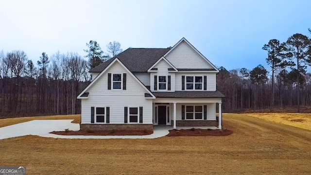 craftsman-style home with covered porch and a front lawn