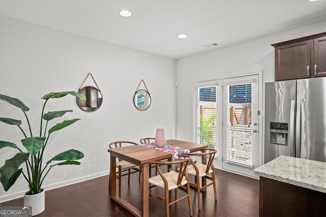 dining area featuring dark wood-type flooring