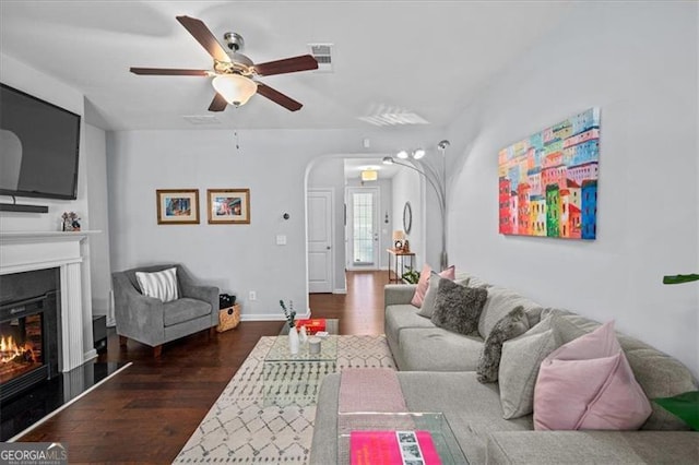 living room featuring dark hardwood / wood-style flooring and ceiling fan