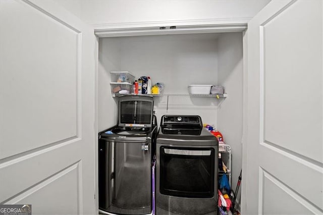 clothes washing area with separate washer and dryer