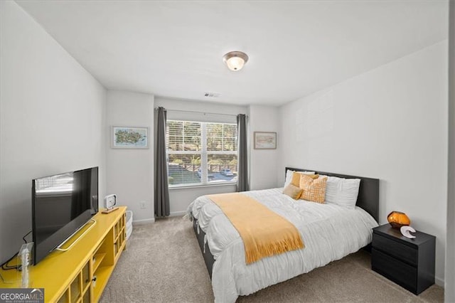 bedroom featuring light carpet