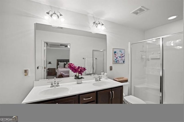 bathroom featuring toilet, vanity, and walk in shower