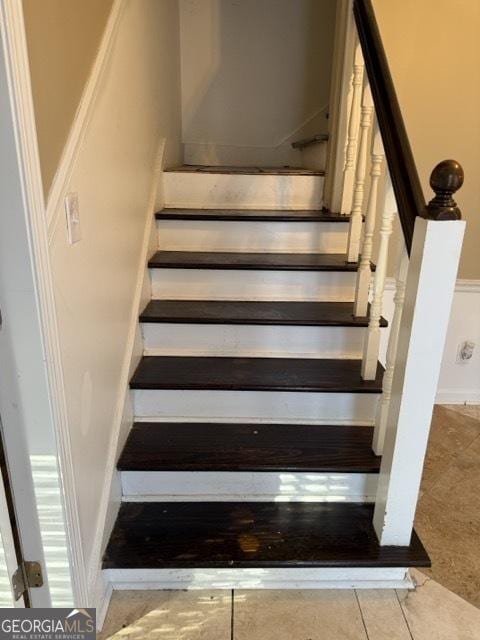 staircase featuring tile patterned flooring