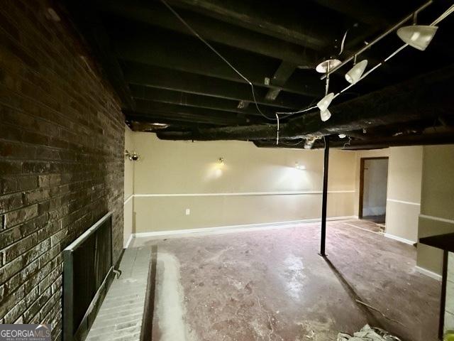 basement with a large fireplace