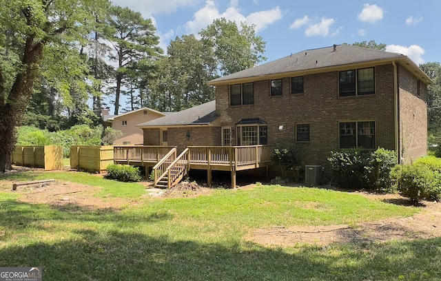 back of house featuring a lawn, central AC unit, and a deck